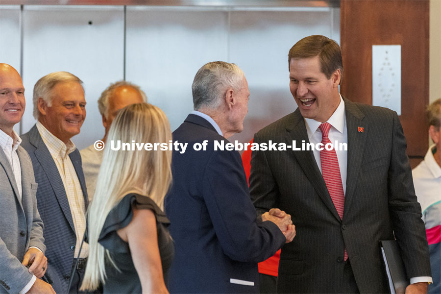 New Nebraska Athletic Director Trev Alberts greets his former coach Tom Osborne as Alberts arrives to the press conference. Alberts returns to his alma mater after spending the last 12 years at UNO. July 14 2021. Photo by Craig Chandler / University Communication.
