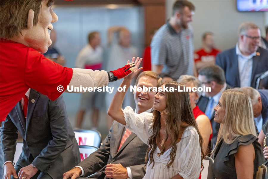 Herbie Husker gives a high five to Breanna Alberts, youngest daughter of new Nebraska Athletic Director Trev Alberts and his wife, Angie, at right. Alberts returns to his alma mater after spending the last 12 years at UNO. July 14 2021. Photo by Craig Chandler / University Communication.