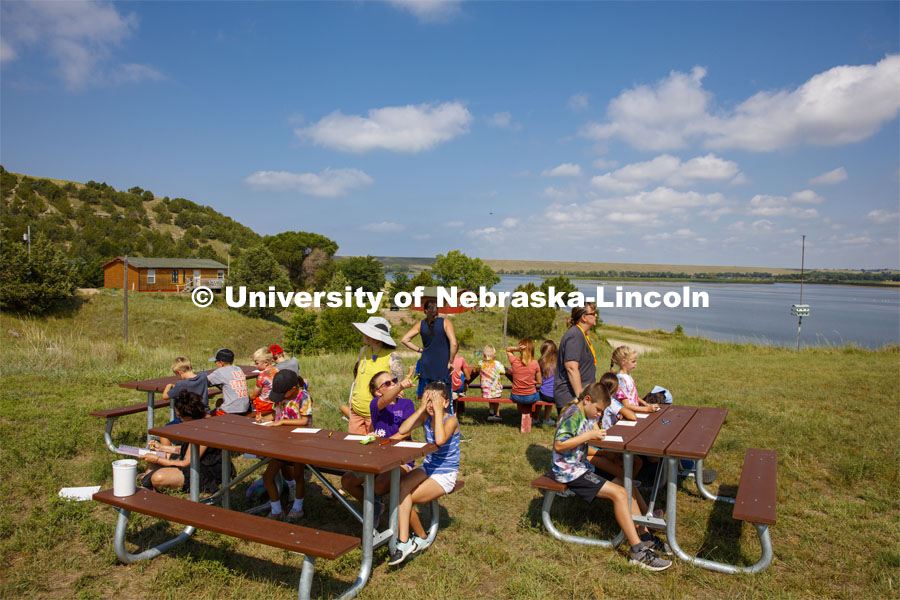 Graduate student Hannah Demma works with campers as they color in their sketches of the Cedar Point skyline. Cedar Point Biological Station near Ogallala, Nebraska. July 19, 2021. Photo by Annie Albin / University Communication.
