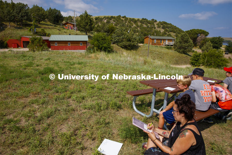 Graduate student Hannah Demma works with campers as they color in their sketches of the Cedar Point skyline. Cedar Point Biological Station near Ogallala, Nebraska. July 19, 2021. Photo by Annie Albin / University Communication.
