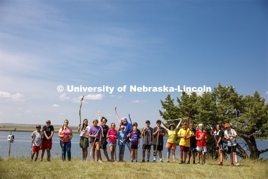 Campers at Adventure Art Camp pose for a picture with their newly painted walking sticks at Cedar Point Station near Lake Ogallala. Cedar Point Biological Station near Ogallala, Nebraska. July 19, 2021. Photo by Annie Albin / University Communication.