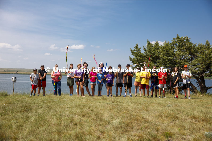 Campers at Adventure Art Camp pose for a picture with their newly painted walking sticks at Cedar Point Station near Lake Ogallala. Cedar Point Biological Station near Ogallala, Nebraska. July 19, 2021. Photo by Annie Albin / University Communication.
