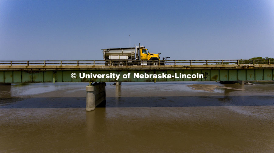 A Nebraska Department of Transportation truck drives across the aging Platte River Bridge as sensors record the movement and vibrations of the bridge. Trucks drove across the bridge singularly and in unison numerous times at varying speeds so the sensors could collect data for each of the runs. NOBL, the Nebraska Outdoor Bridge Lab as part of the College of Engineering is turning two bridge sites (for a total of three bridges) into a national research and educational facility for bridge health and testing. This bridge is across the Platte River on Highway 92 between Yutan and Omaha. August 9, 2021. Photo by Craig Chandler / University Communication.