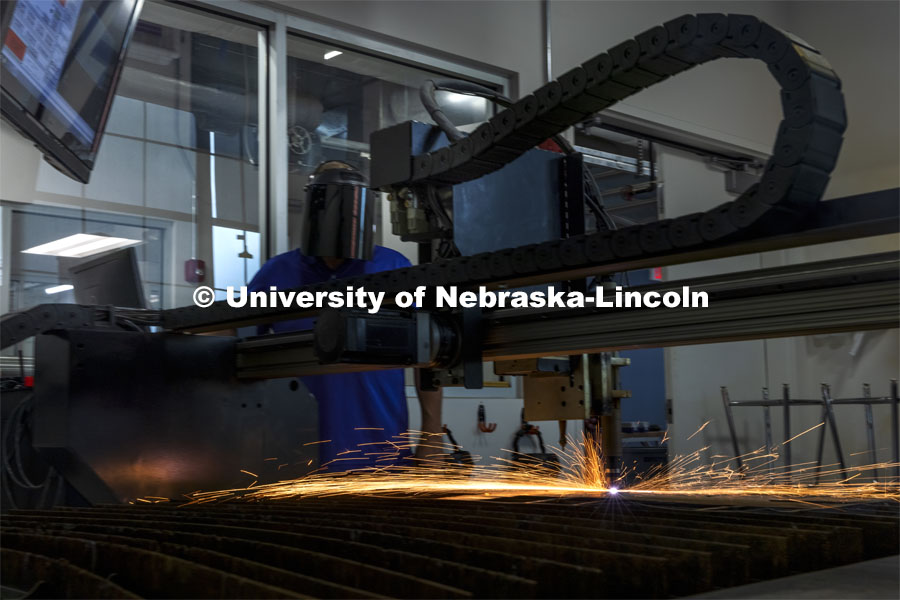 Jerry Reif, shop manager at Nebraska Innovation Studio, watches as a plasma cutter cuts through steel. Nebraska Innovation Campus. August 10, 2021. Photo by Craig Chandler / University Communication.