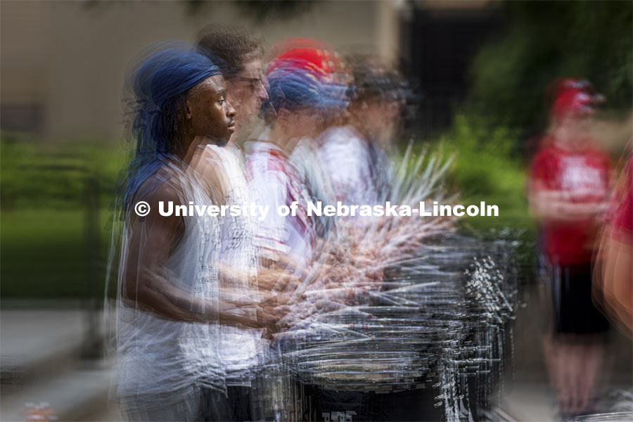 The sticks are flying as Tamario Brooks and the Cornhusker Marching Band snare line practices Thursday evening in this multiple exposure image. The Cornhusker Marching Band percussion groups kick off the school year. The battery practices outside of the Sheldon Thursday afternoon.  August 12, 2021. Photo by Craig Chandler / University Communication.