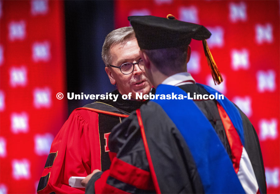 Chancellor Ronnie Green hands out each person’s diploma and talks for a moment with each new graduate. Summer Graduate Commencement at Pinnacle Bank Arena. August 13, 2021. Photo by Craig Chandler / University Communication.