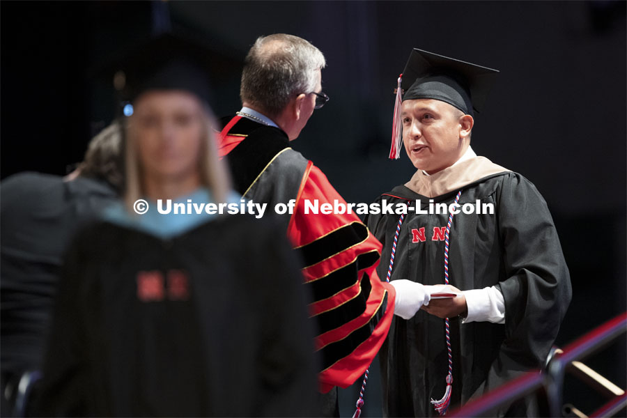 Diego Sanchez receives his MBA from Chancellor Ronnie Green. Summer Graduate Commencement at Pinnacle Bank Arena. August 13, 2021. Photo by Craig Chandler / University Communication.