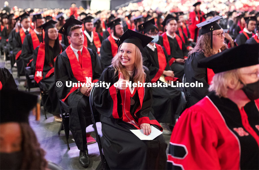 2020 Chancellors Scholar Clair Trenhaile gives a thumbs up to her family and friends in the stands. The scholars were recognized on stage during the commencement. Undergraduate Commencement at Pinnacle Bank Arena. August 14, 2021. Photo by Craig Chandler / University Communication.