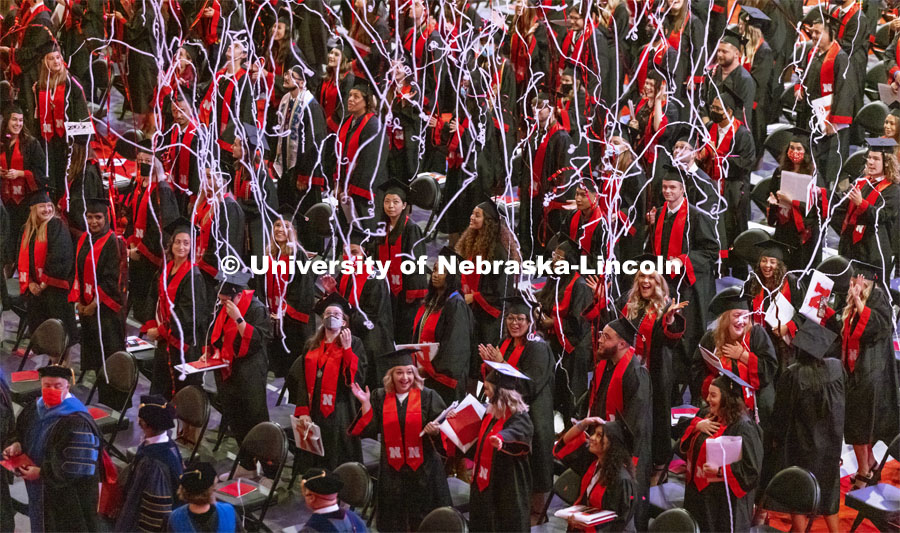 Streamers float down on the graduates at August commencement ceremony. Undergraduate Commencement at Pinnacle Bank Arena. August 14, 2021. Photo by Craig Chandler / University Communication.
