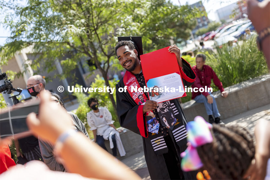 2020 graduate Japrice Ta’Zhon Green shows off his certificate given to all the graduates who returned to campus to walk in the August ceremony. Undergraduate Commencement at Pinnacle Bank Arena. August 14, 2021. Photo by Craig Chandler / University Communication.