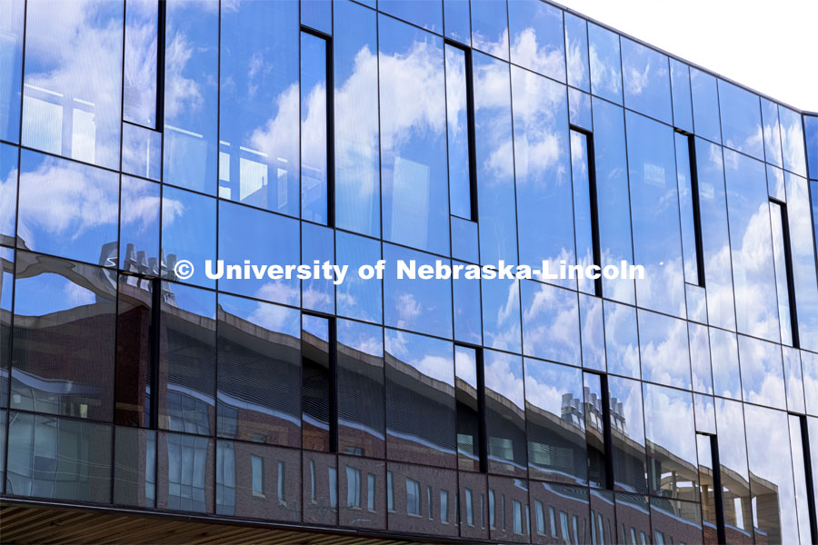 Jorgensen Hall is reflected in the Phase 1 facade of the Scott Engineering Center renovations. August 15, 2021. Photo by Craig Chandler / University Communication.