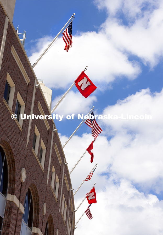 Flags fly outside of Memorial Stadium. American and Husker flags. August 16, 2021. Photo by Craig Chandler / University Communication.