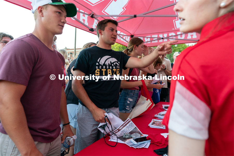 Students form a large line to get free Husker merchandise during the Big Red Welcome Street Festival. The Street Festival was held on East Memorial Stadium Loop between the College of Business and Memorial Stadium. August 22, 2021. Photo by Jordan Opp for University Communication.