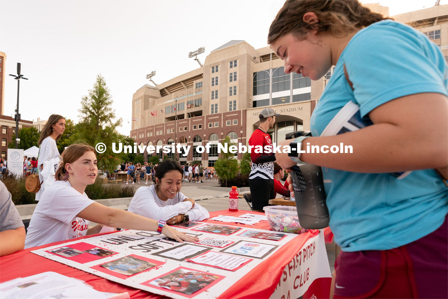 A student talks to club representatives during the Big Red Welcome Street Festival. The Street Festival was held on East Memorial Stadium Loop between the College of Business and Memorial Stadium. August 22, 2021. Photo by Jordan Opp for University Communication.