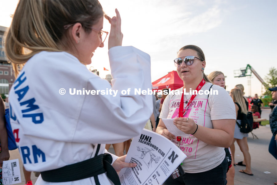 A student talks to a club representative during the Big Red Welcome Street Festival. The Street Festival was held on East Memorial Stadium Loop between the College of Business and Memorial Stadium. August 22, 2021. Photo by Jordan Opp for University Communication.