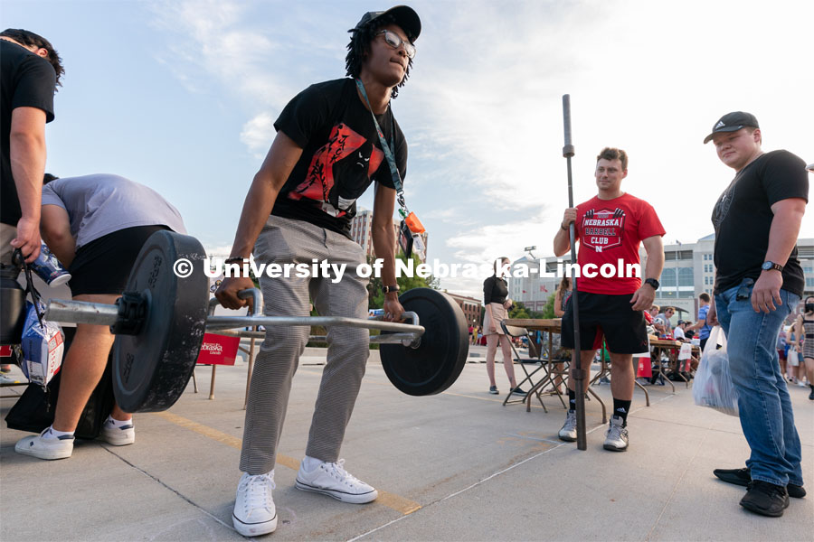 Students take turns deadlifting during the Big Red Welcome Street Festival. The Street Festival was held on East Memorial Stadium Loop between the College of Business and Memorial Stadium. August 22, 2021. Photo by Jordan Opp for University Communication.