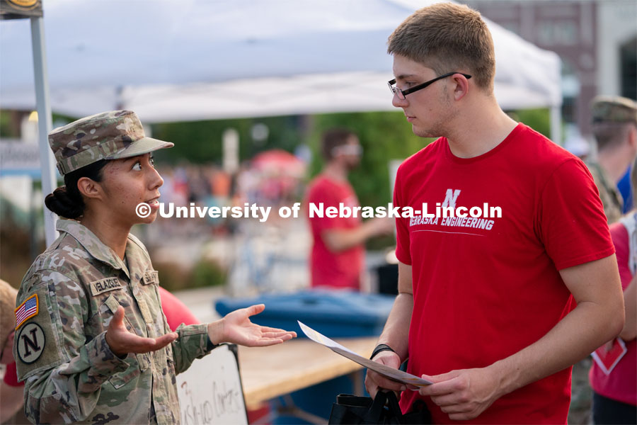 A student talks to an Army recruiter during the Big Red Welcome Street Festival. The Street Festival was held on East Memorial Stadium Loop between the College of Business and Memorial Stadium. August 22, 2021. Photo by Jordan Opp for University Communication.