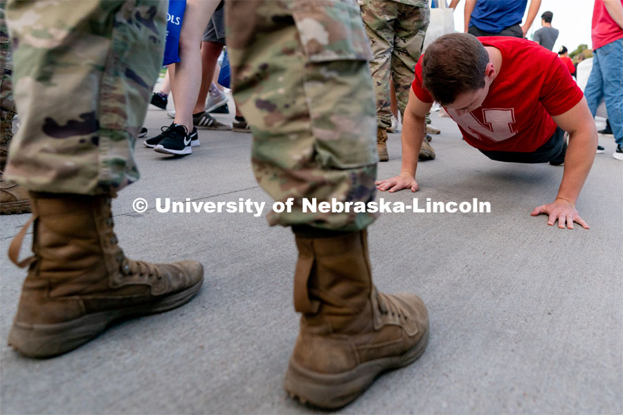 Students try to do as many push-ups as possible in one minute at the Big Red Welcome Street Festival. The Street Festival was held on East Memorial Stadium Loop between the College of Business and Memorial Stadium. August 22, 2021. Photo by Jordan Opp for University Communication.