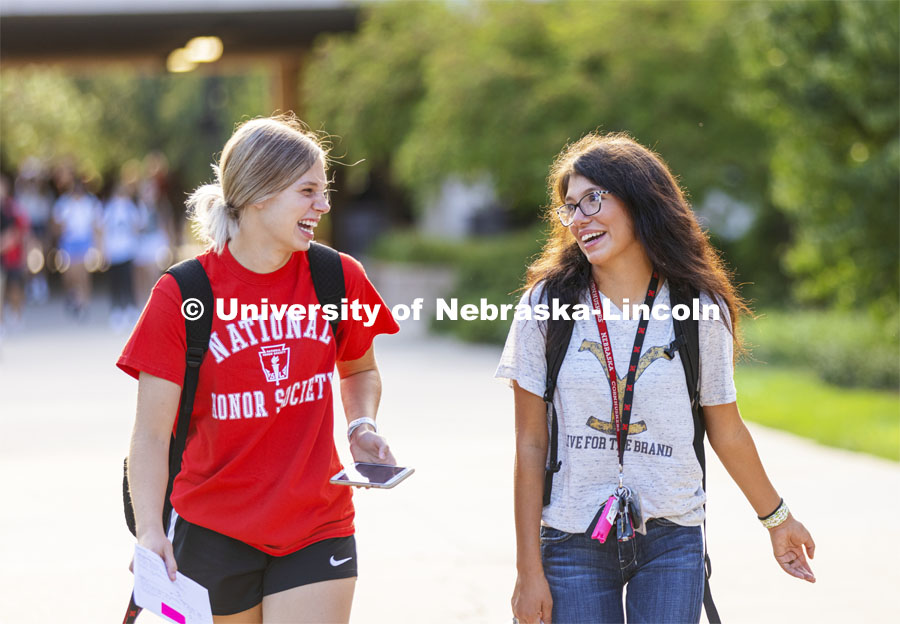Korrina Niemann of Wayne, Nebraska, and Alexis Rutar of Springview, Nebraska, enjoy a laugh as they head for their first class of the day. First day of classes for fall semester. August 23, 2021. Photo by Craig Chandler / University Communication.