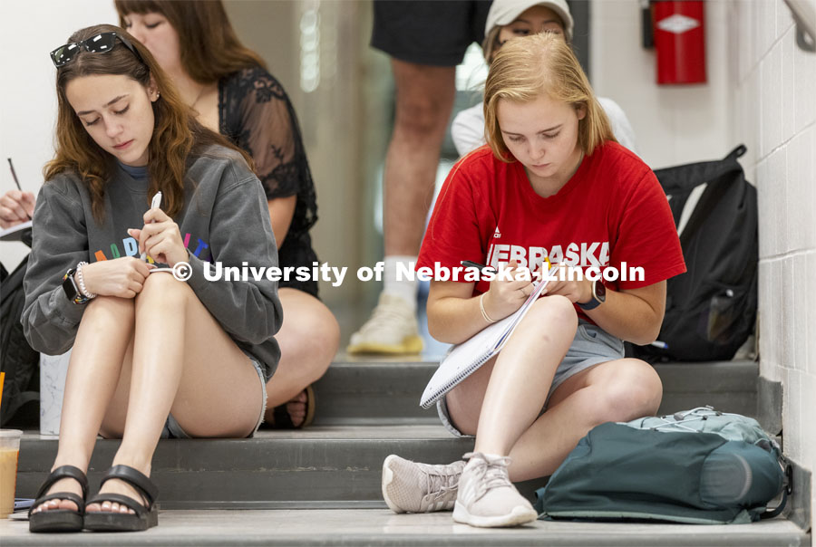 The last students in the door of Chemistry 110 lecture in Hamilton Hall chose to sit on the steps rather than work their way into the seats. First day of classes for fall semester. August 23, 2021. Photo by Craig Chandler / University Communication.