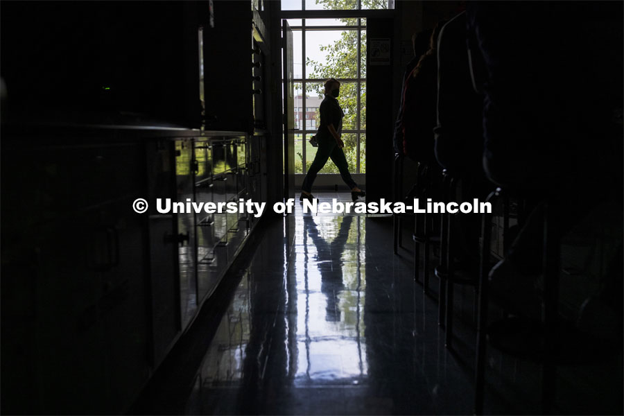 A person is framed by the doorway in Beadle Hall. First day of classes for fall semester. August 23, 2021. Photo by Craig Chandler / University Communication.