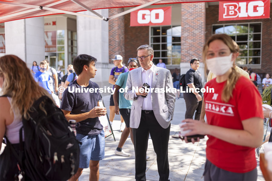 Chancellor Ronnie Green talks to Josh Rodriguez at the Inaugural Soph S’more Social outside of the Nebraska Union. A special Dairy Store flavor was given out to sophomores, friends of sophomores, and anyone who was once a sophomore to celebrate them being back on campus. August 25, 2021. Photo by Craig Chandler / University Communication.