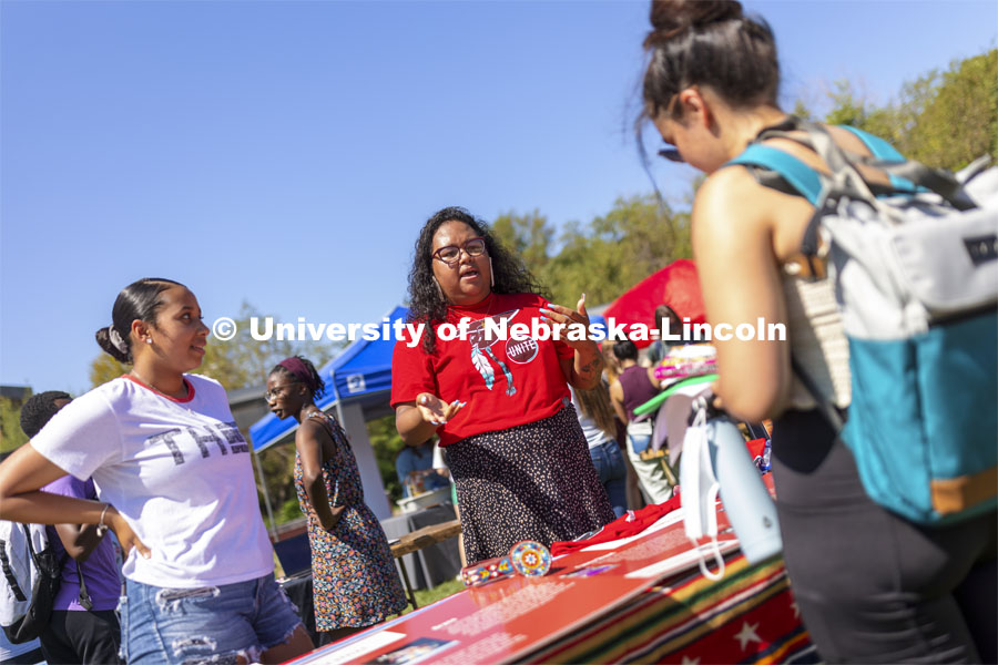 Nasia Olson-White Feather of Red Lake, MN, talks with a student at the UNITE table as Jaicein Mayfield listens in. Club Fair at City Campus. More than 130 recognized student organizations (RSOs) to join for social, professional and leadership interests. RSO members and officers will be on hand to provide details about their organization and answer questions from prospective new members. August 25, 2021. Photo by Craig Chandler / University Communication