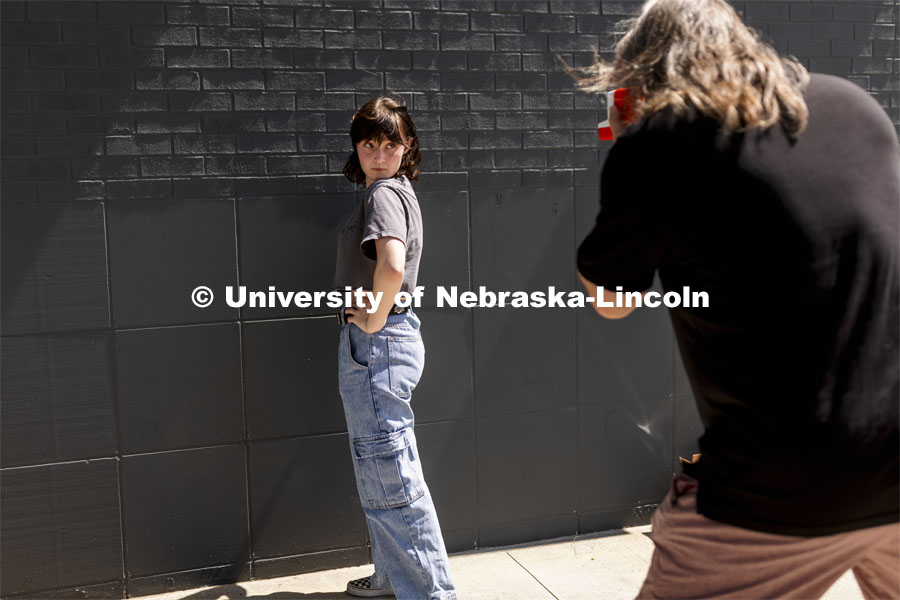 Olivia Jenkins, a sophomore from Lincoln, poses for her photo being taken by Sean Strough, Equipment and Technology Associate for the Johnny Carson Center for Emerging Media Arts. Carson students gathered outside the building Friday afternoon for picture day. The photos were done on old school Polaroid instant film. The images will be posted in the center so all the students can know each other better. August 27, 2021. Photo by Craig Chandler / University Communication.