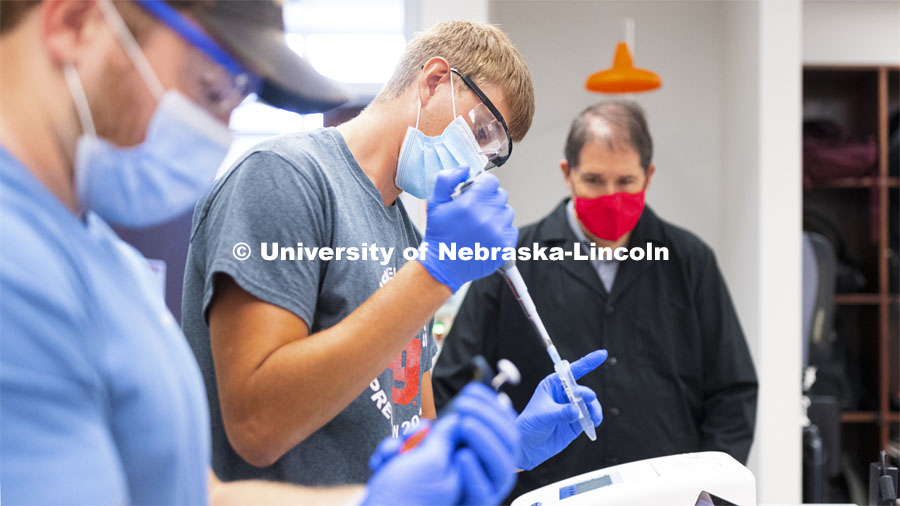 Austin Streeter, senior from West Point, Nebraska, pipettes liquids during his Biochemistry 401 lab Beadle Hall as Mark Behrens, biochemistry lab manager, observes. September 1, 2021. Photo by Craig Chandler / University Communication.