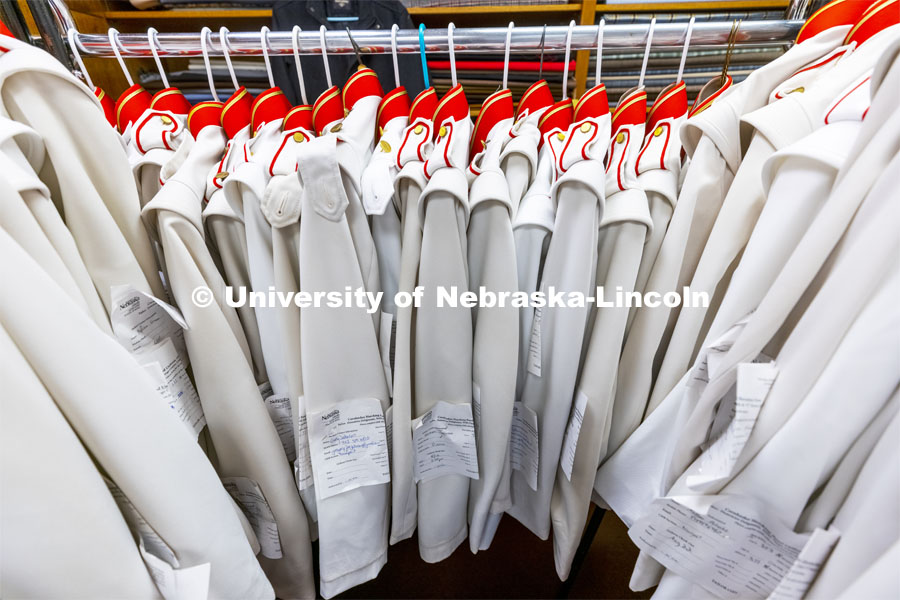 Altered band uniforms await pick up. Demetrios and Stamatia Delgiannis have been altering the Cornhusker Marching Band uniforms for 50 years from their Lincoln tailoring business. September 1, 2021. Photo by Craig Chandler / University Communication.