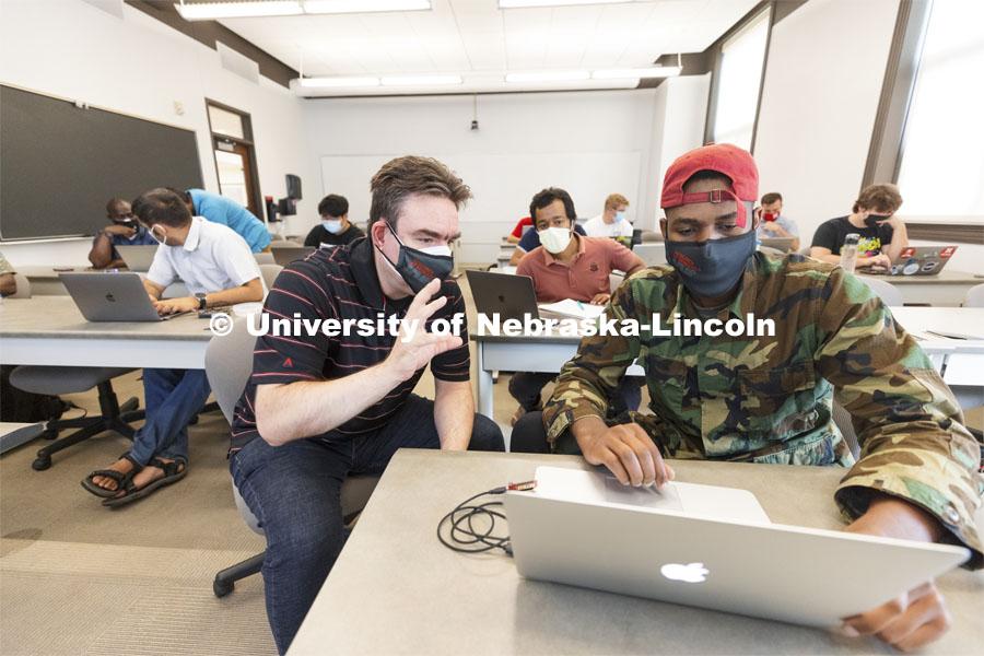 Mehmet Can Vuran works with Joshua Datto, first year graduate student from Rwanda, on his programming questions. Students in Mehmet Can Vuran’s Internet of Things Lab in Avery Hall work with sensors programming in class. September 3, 2021. Photo by Craig Chandler / University Communication.