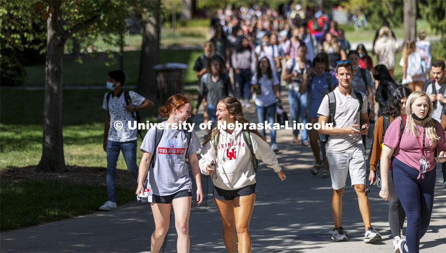 Peyton Kullmann, a freshman from Philadelphia, and Anna Wibbels, a freshman from Hastings, laugh while walking across campus Wednesday. City Campus outside the Nebraska Union. September 8, 2021. Photo by Craig Chandler / University Communication.