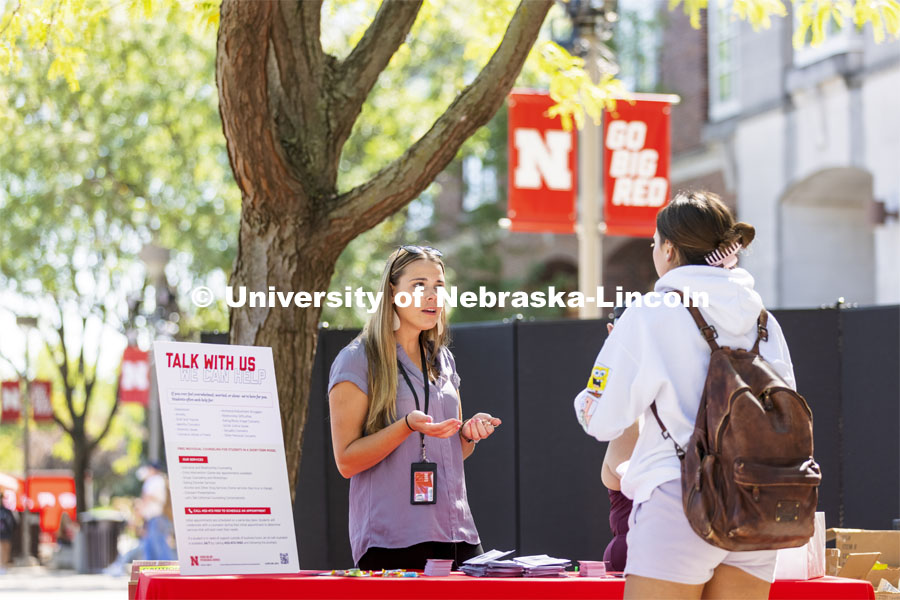 Mariah Petersen, a CAPS outreach coordinator talks with a student at the counseling and psychological services booth during the Campus Safety Awareness Fair outside the Nebraska Union. September 8, 2021. Photo by Craig Chandler / University Communication.