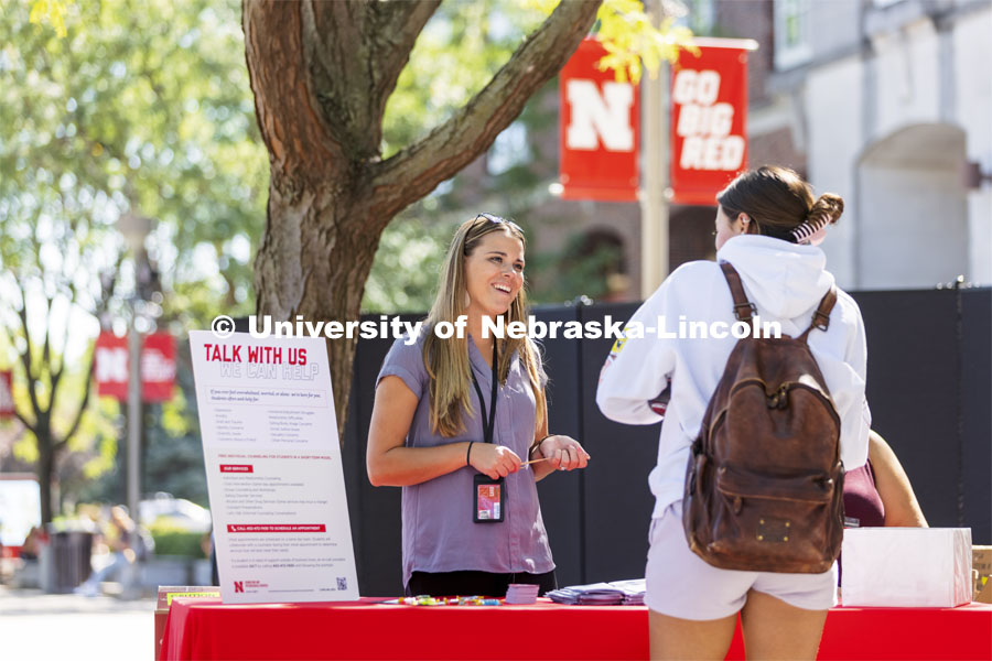 Mariah Petersen, a CAPS outreach coordinator talks with a student at the counseling and psychological services booth during the Campus Safety Awareness Fair outside the Nebraska Union. September 8, 2021. Photo by Craig Chandler / University Communication.