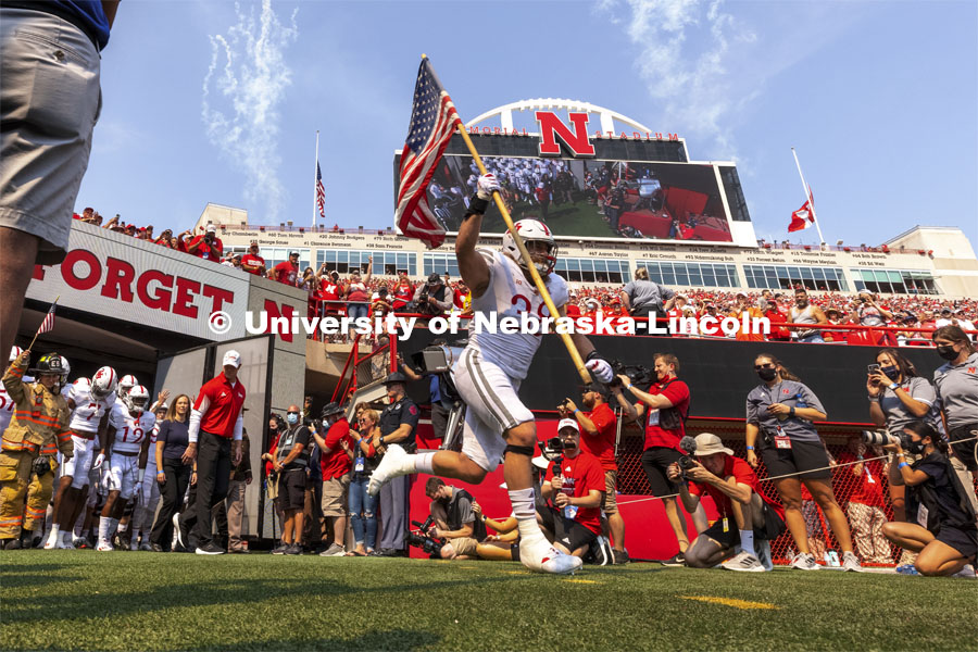 Damian Jackson, a former Navy Seal and current Husker linebacker, carried the flag for the tunnel walk. Nebraska vs. Buffalo University game on the 20th anniversary of 9/11. Photo by Craig Chandler / University Communication.