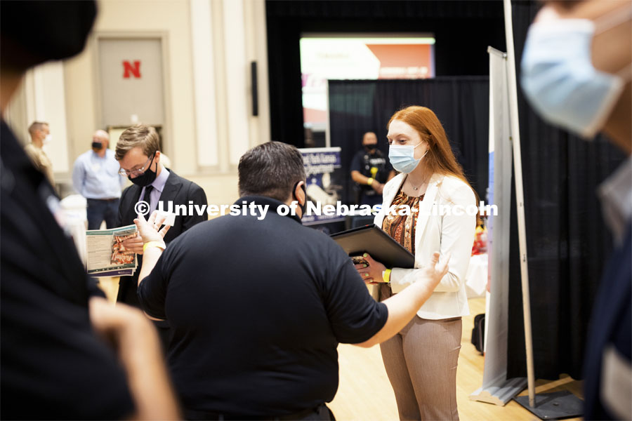 Meghan Schuette, a senior in international business and marketing, talks with Jonathan Fast, an Union Pacific recruiter at Tuesday’s Career Fair.  Day 1’s career opportunities center around the following career pathways: Business, Management and Operations, Training, Government & Public Administration, Human Services & Non-profit, Law, Public Safety & Security, Health & Public Health.  September 21, 2021. Photo by Craig Chandler / University Communication
