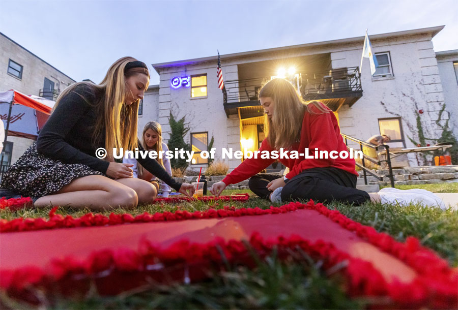 Mary Foster and Morgan (no last name given) of the Chi Omega sorority decorate outside the Theta Xi fraternity Thursday evening. Homecoming decorating. September 30, 2021. Photo by Craig Chandler / University Communication