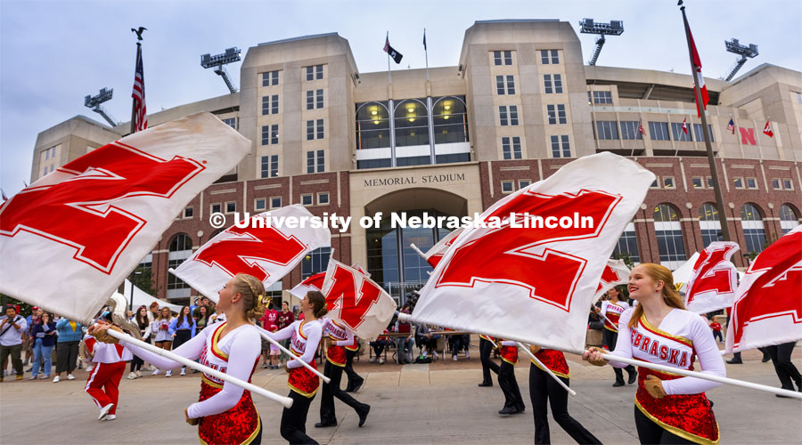 The Cornhusker Marching Band Color Guard march past the Cornstalk Festival crowd at Memorial Stadium. Homecoming Parade and Cornstalk Festival. October 1, 2021. Photo by Craig Chandler / University Communication.