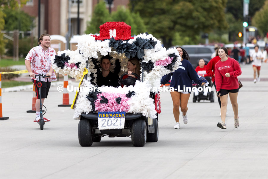 A golf cart decorated like a cow is part of the Homecoming Parade. Homecoming Parade and Cornstalk Festival. October 1, 2021. Photo by Craig Chandler / University Communication