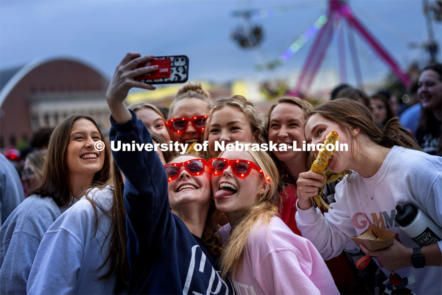 Hailey Olberding, left, and Kellie Kaufman take a selfie with their friends. Homecoming Parade and Cornstalk Festival. October 1, 2021. Photo by Craig Chandler / University Communication.