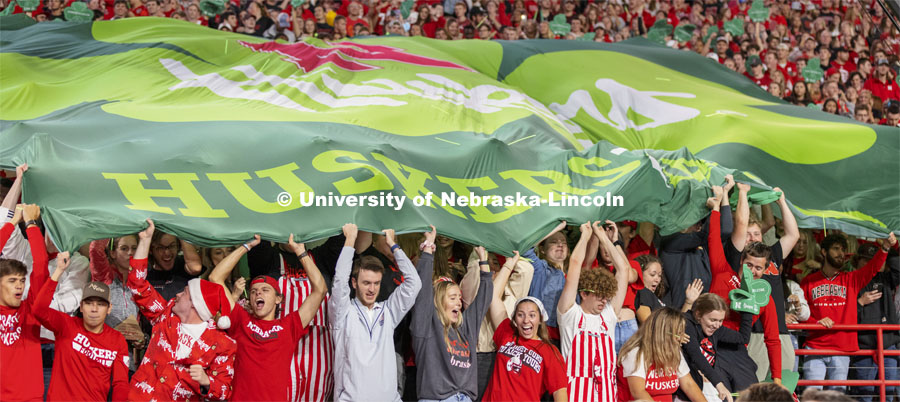 The student section holds a large shamrock Husker flag to help promote the 2022 Nebraska vs Northwestern University game that is to be played in Ireland.  October 2, 2021. Photo by Craig Chandler / University Communication.
