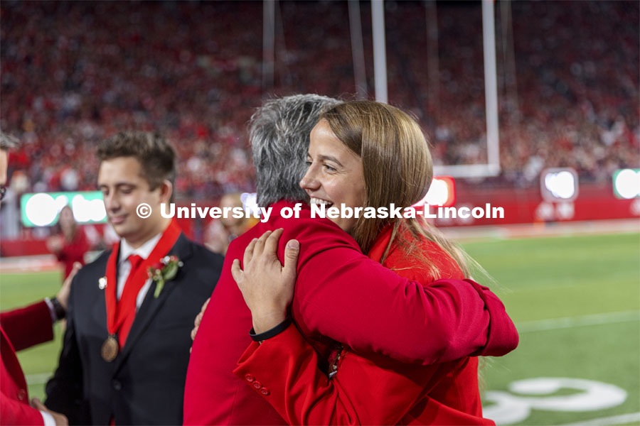 Leigh Jahnke of West Point gets a hug from Husker Jane Green after being named homecoming royalty at the University of Nebraska–Lincoln. Nebraska vs Northwestern University homecoming game. October 2, 2021. Photo by Craig Chandler / University Communication.
