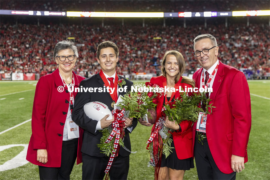 Seniors Bobby Martin of Omaha and Leigh Jahnke of West Point were crowned homecoming royalty at the University of Nebraska–Lincoln. Nebraska vs Northwestern University homecoming game. They are posing with Jane Green and Chancellor Ronnie Green. October 2, 2021. Photo by Craig Chandler / University Communication.