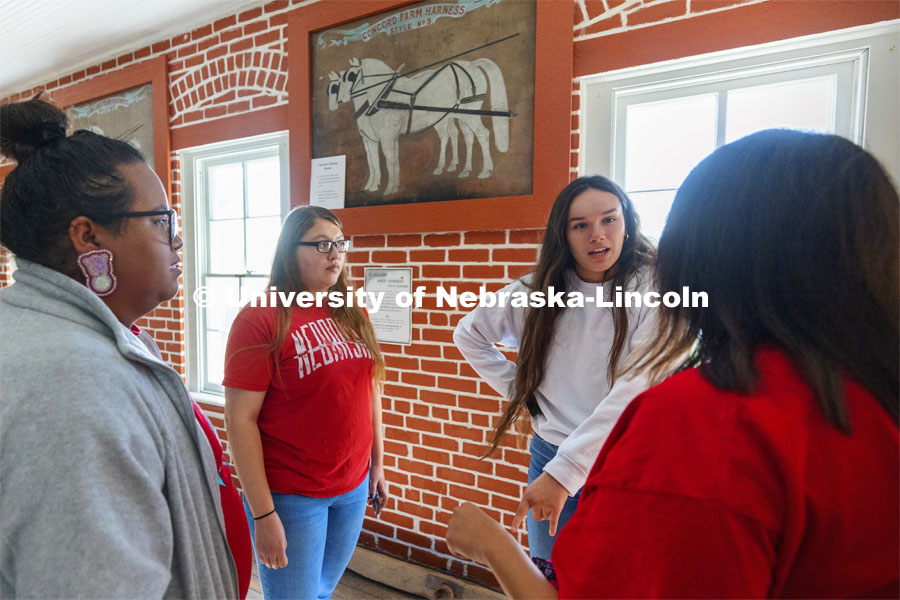 Jean Parker-Morris explains that her great grandfather was sent to the school and learned carpentry and she is walking on the same floors he once did. Students from UNITE tour the Genoa Indian School in Genoa, Nebraska. October 10, 2021. Photo by Craig Chandler / University Communication.