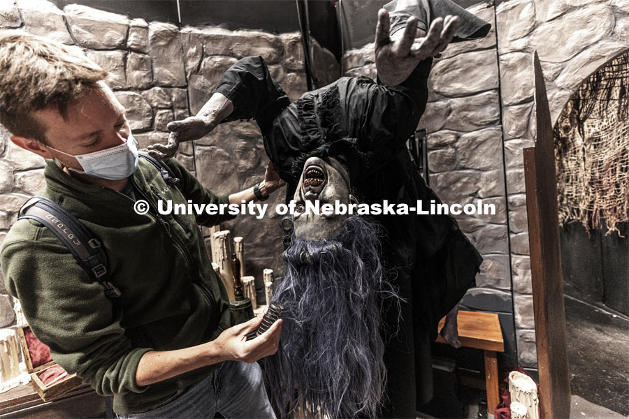 Andy Park, The Nebraska Repertory Theatre creative director, adjusts the hair on one of the animated ghouls. The group has turned Howell Theatre’s stage and backstage into a haunted house with a Shakespeare twist. ShakesFEAR opens October 15 and runs through Halloween. October 12, 2021. Photo by Craig Chandler / University Communication.
