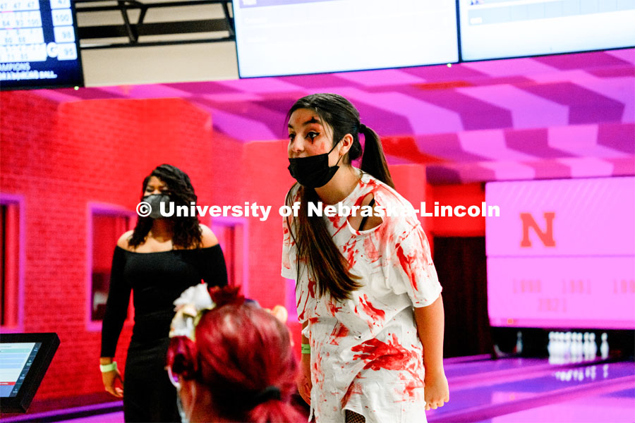 Students at Nightmare at East Campus. Students enjoy a fun-tastic night of indoor Halloween-themed activities and treats in the Nebraska East Union. Students wore costumes to participate in a costume contest, laser tag, pumpkin painting, bowling and a hayrack ride. October 28, 2021. Photo by Jonah Tran / University Communication. 