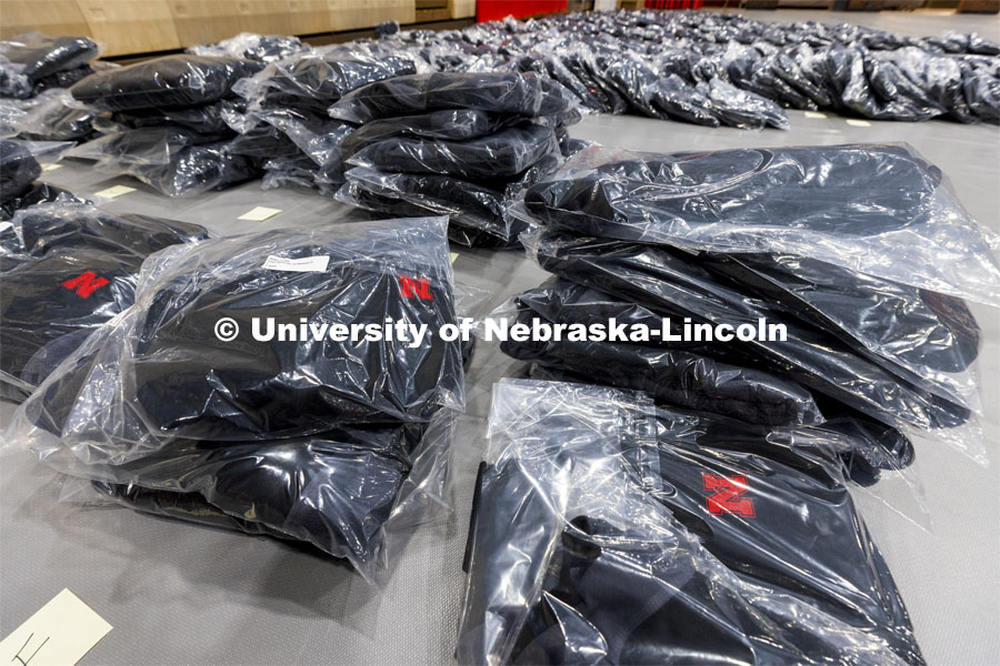 Stacks of fleece jackets await pick up from employees who are being honored for their years of service. Salute to Service gathering in the Coliseum. November 18, 2021. Photo by Craig Chandler / University Communication.