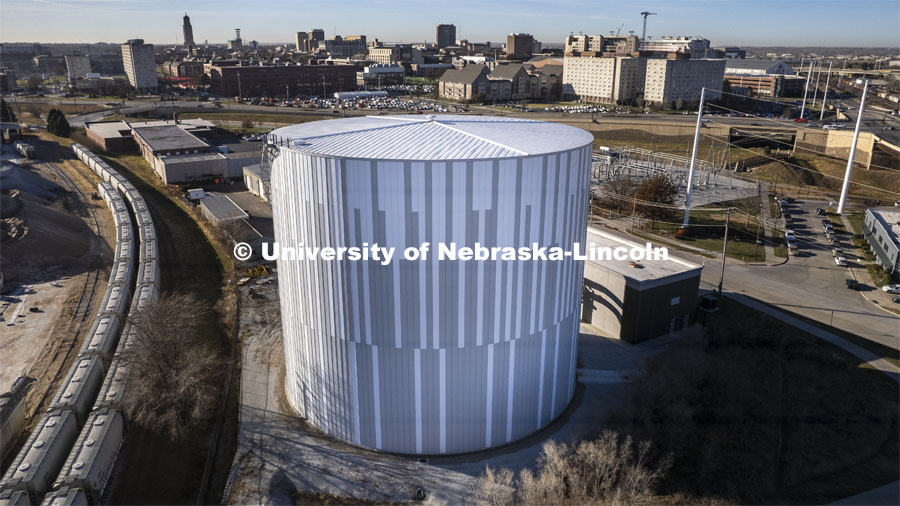 The 8.1-million-gallon thermal energy storage tank northeast of city campus works like a battery, holding chilled water in reserve to cool campus buildings during peak demand periods. The system reduces energy costs by chilling stored water when energy use on campus is low, primarily at night and on weekends. December 2, 2021. Photo by Craig Chandler / University Communication.