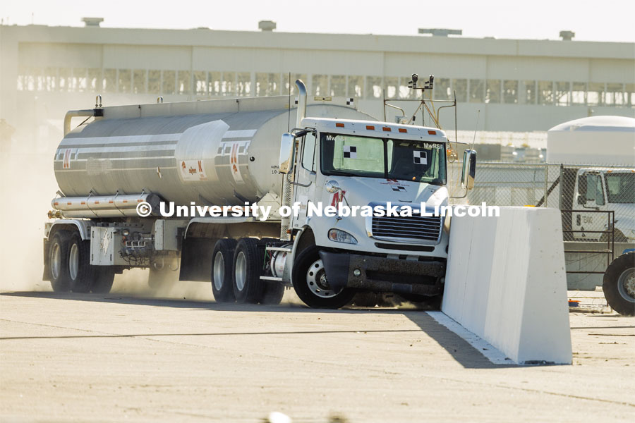 The roadside barrier developed by University of Nebraska–Lincoln researchers holds firm as a fully-loaded tractor-tanker vehicle slams into it during a Dec. 8 test. Researchers from the Midwest Roadside Safety Facility conducted a rare tractor-tanker crash to test how a newly designed and significantly less tall concrete roadside barrier performs in a crash. The test was at the facility’s Outdoor Proving Grounds on the western edge of the Lincoln Municipal Airport. December 8, 2021. Photo by Craig Chandler / University Communication.