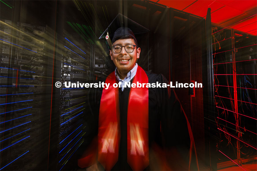 Bryan Chavez, a first-generation student who graduates Dec. 18 with degrees in computer science and mathematics, stands in front of a supercomputer in the Holland Computing Center. Chavez's success on campus was fueled by support received through the Nebraska College Prep Academy. December 09, 2021. Photo by Craig Chandler / University Communication.